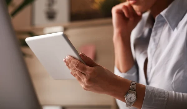 close-up-female-entrepreneur-reading-business-reports-digital-tablet-office